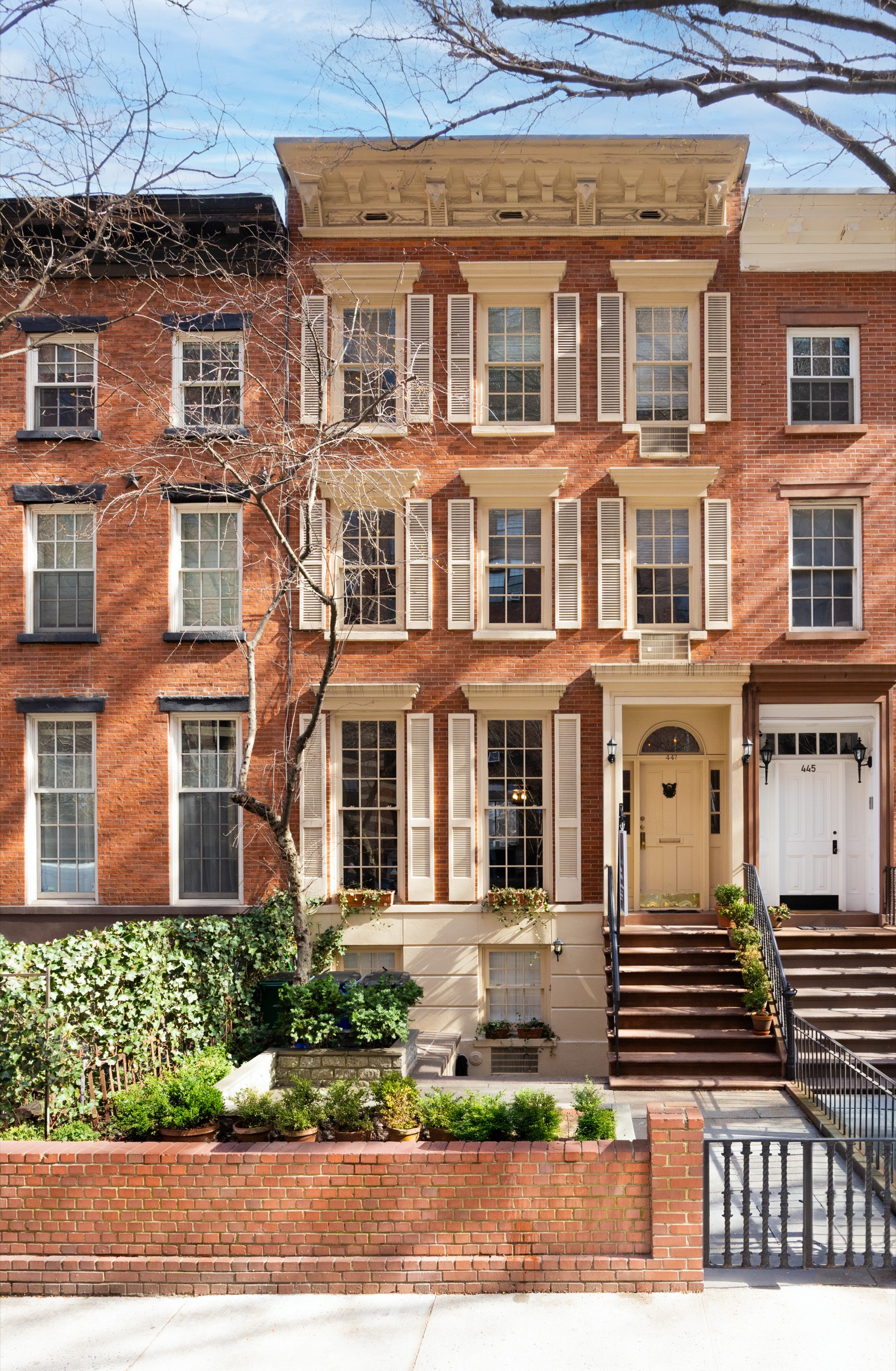 Brick townhouse facade with planted stoop